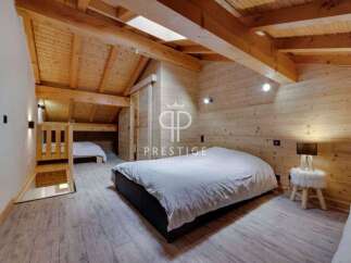 Discover the charm of this cozy bedroom, featuring a unique wooden design that exudes warmth and character.