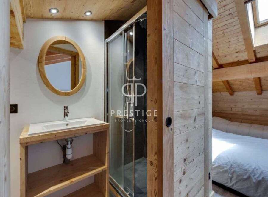Discover the charm of this cozy bathroom, featuring a stylish wooden vanity and a sleek shower enclosure.