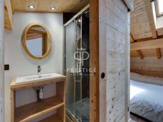 Discover the charm of this cozy bathroom, featuring a stylish wooden vanity and a sleek shower enclosure.