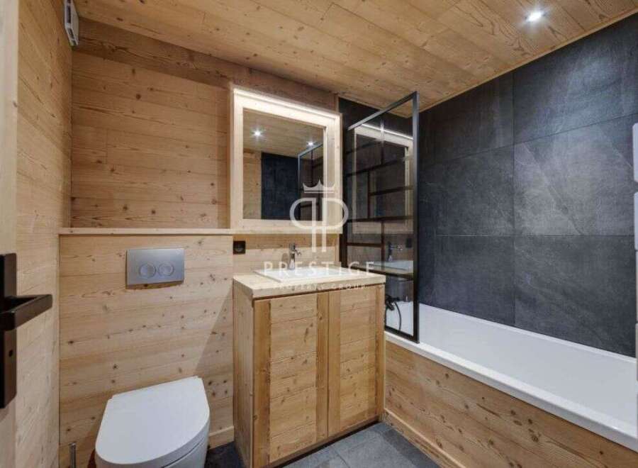 Step into a beautifully designed bathroom featuring natural wood paneling that exudes warmth and rustic charm.