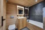 Step into a beautifully designed bathroom featuring natural wood paneling that exudes warmth and rustic charm.