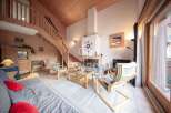 Discover the charm of this cozy chalet, featuring a stunning wooden interior and a welcoming fireplace.