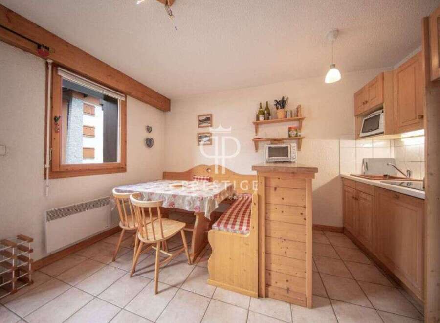 Cozy kitchen with wooden cabinets and a dining area.