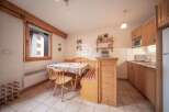 Cozy kitchen with wooden cabinets and a dining area.