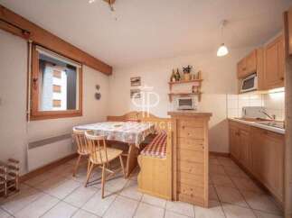 Cozy kitchen with wooden cabinets and a dining area.
