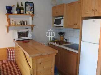 Cozy kitchen with wooden cabinets and a built-in microwave.