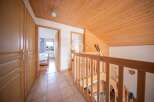 Discover the charm of this inviting property, featuring a warm wooden ceiling and staircase.