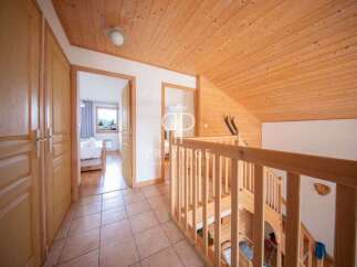 Discover the charm of this inviting property, featuring a warm wooden ceiling and staircase.