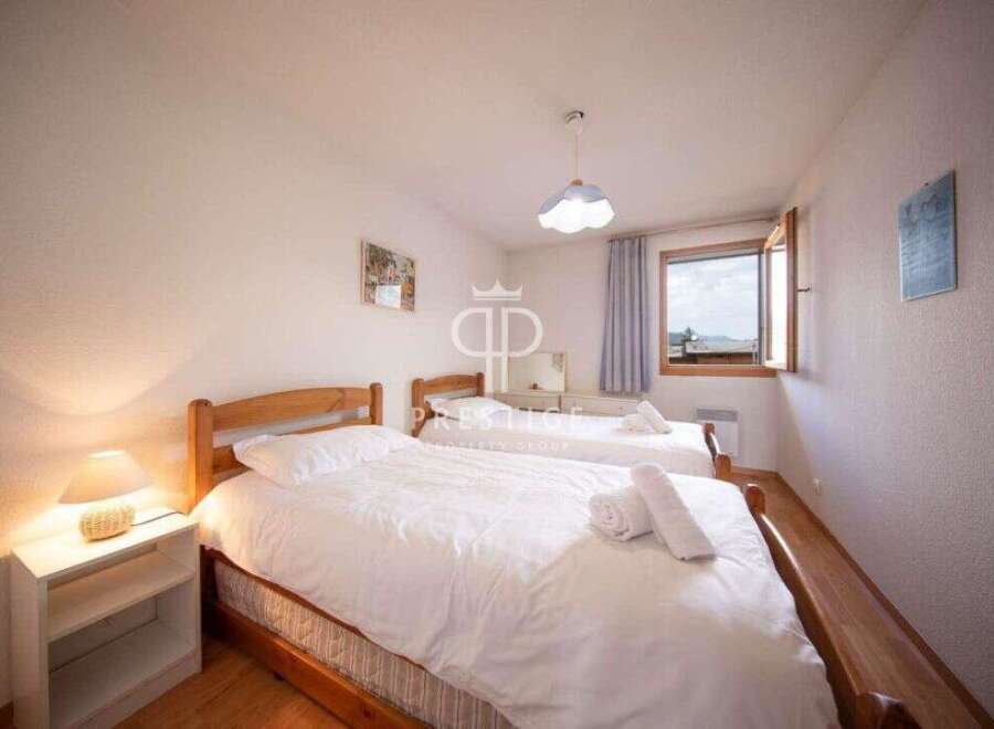 Discover a cozy bedroom with two comfortable beds, perfect for a relaxing stay.