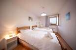 Discover a cozy bedroom with two comfortable beds, perfect for a relaxing stay.