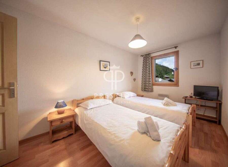 Cozy bedroom with two beds, perfect for a comfortable stay.