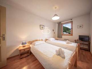 Cozy bedroom with two beds, perfect for a comfortable stay.