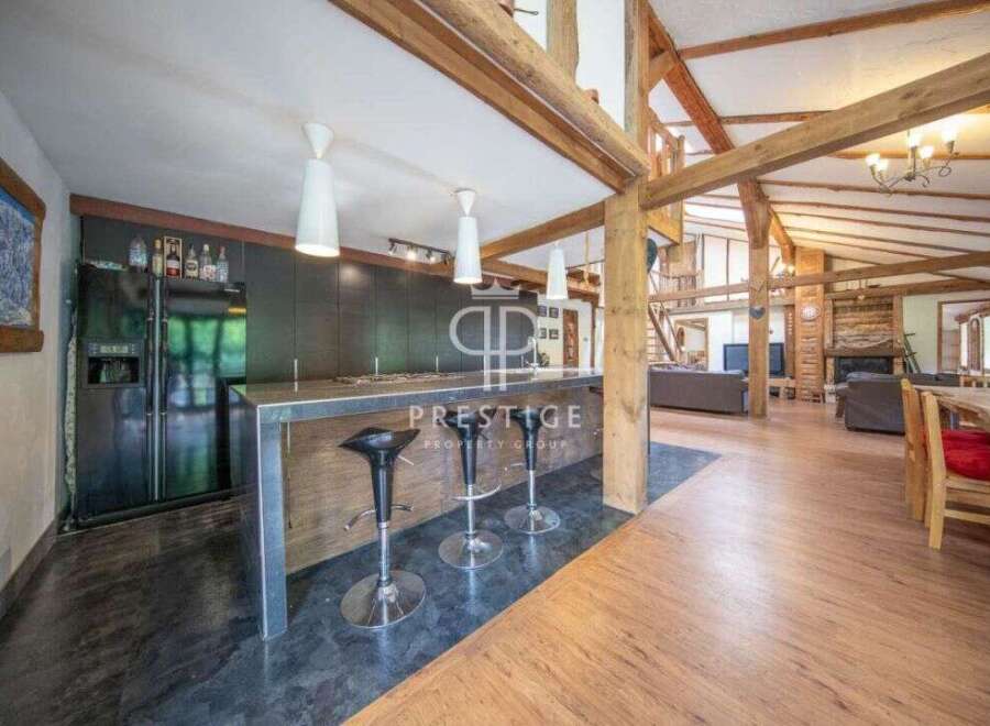 Discover luxury living in this stunning property! Featuring a modern kitchen with a sleek bar, perfect for entertaining.