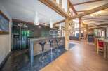 Discover luxury living in this stunning property! Featuring a modern kitchen with a sleek bar, perfect for entertaining.