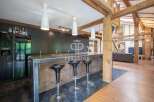 Discover luxury living in this stunning property! Featuring a modern kitchen with sleek countertops and stylish bar stools, perfect for entertaining.
