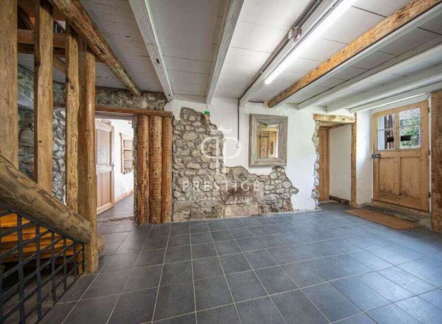 Discover the rustic charm of this property, featuring exposed wooden beams and stone walls that exude character.