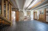 Discover the rustic charm of this property, featuring exposed wooden beams and stone walls that exude character.