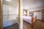 Discover the charm of this unique property, featuring a cozy bedroom with a rustic wooden bed frame.