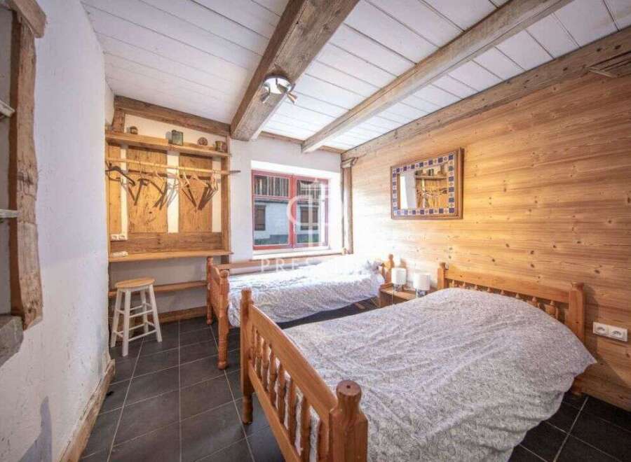 Discover the charm of this cozy bedroom, featuring rustic wooden accents and a warm, inviting atmosphere.