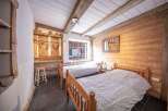 Discover the charm of this cozy bedroom, featuring rustic wooden accents and a warm, inviting atmosphere.