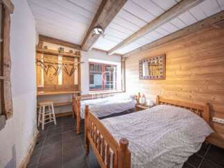 Discover the charm of this cozy bedroom, featuring rustic wooden accents and a warm, inviting atmosphere.