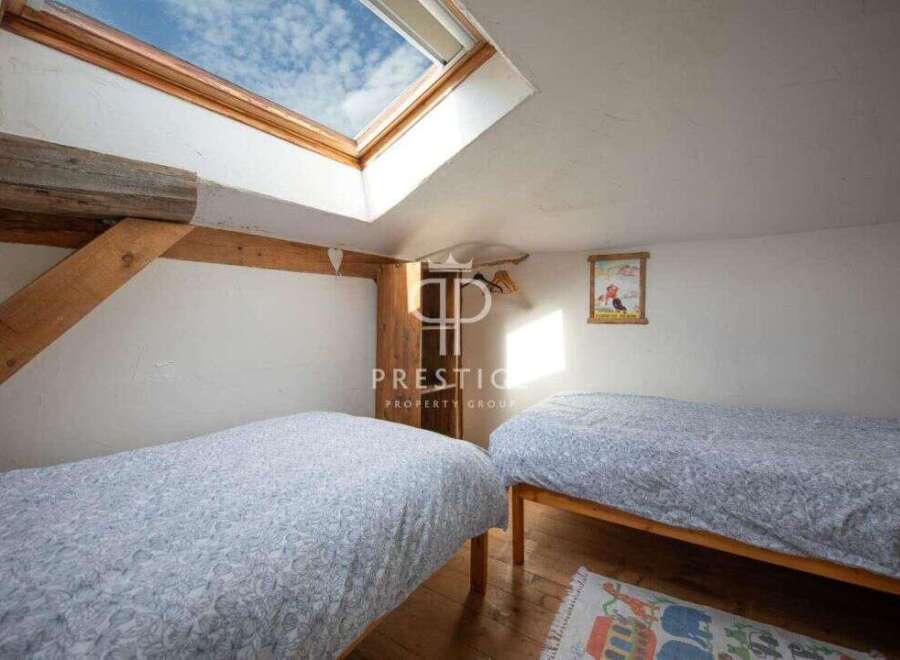 Discover a charming bedroom with a unique skylight, perfect for natural light.