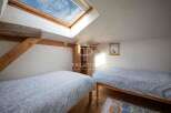 Discover a charming bedroom with a unique skylight, perfect for natural light.