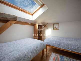 Discover a charming bedroom with a unique skylight, perfect for natural light.