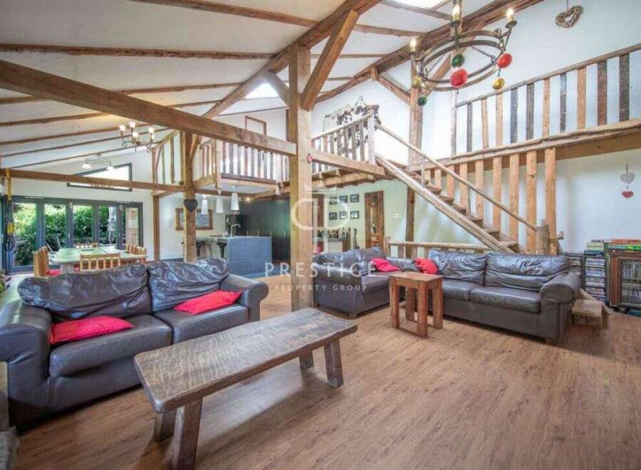 Experience rustic elegance in this stunning property, featuring exposed wooden beams and a unique architectural design.