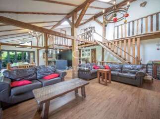 Experience rustic elegance in this stunning property, featuring exposed wooden beams and a unique architectural design.