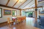 This stunning property boasts a unique dining area with exposed wooden beams and a rustic wooden table, creating a warm and inviting atmosphere.