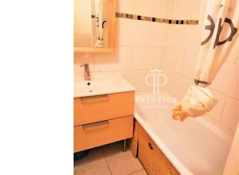 Discover this charming bathroom featuring a modern vanity and a relaxing bathtub.