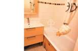 Discover this charming bathroom featuring a modern vanity and a relaxing bathtub.