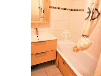 Discover this charming bathroom featuring a modern vanity and a relaxing bathtub.
