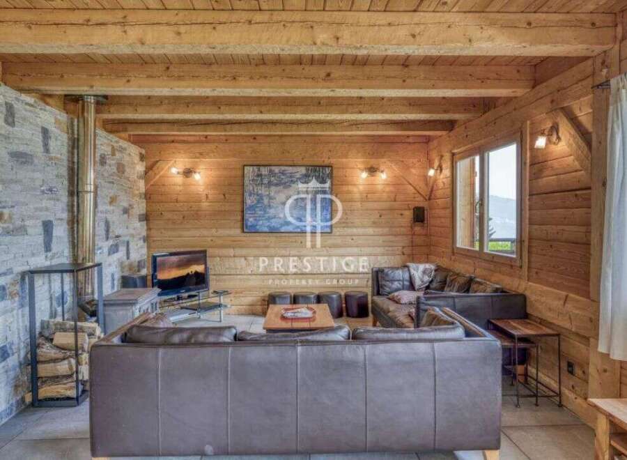 Experience rustic luxury in this stunning property, featuring warm wooden interiors and a cozy fireplace.