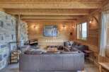 Experience rustic luxury in this stunning property, featuring warm wooden interiors and a cozy fireplace.