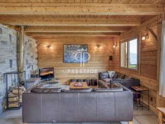 Experience rustic luxury in this stunning property, featuring warm wooden interiors and a cozy fireplace.
