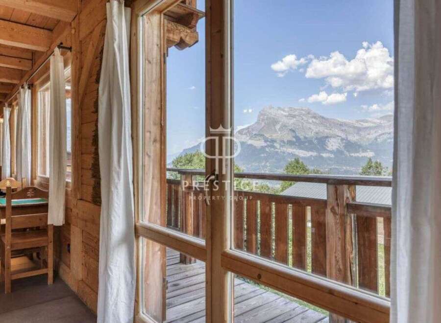 Experience breathtaking mountain views from this charming wooden chalet.