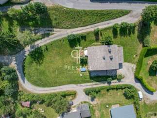 Discover a stunning property nestled in a serene, green landscape.