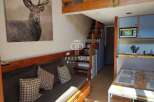 Discover this charming property featuring a cozy living space with a comfortable sofa and decorative pillows.