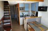 Cozy and compact living at its finest! This charming property features a well-equipped kitchen with modern appliances and stylish blue cabinetry.