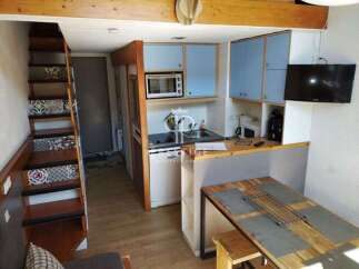 Cozy and compact living at its finest! This charming property features a well-equipped kitchen with modern appliances and stylish blue cabinetry.