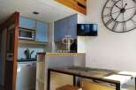 Discover this charming property featuring a well-equipped kitchen with modern appliances and stylish blue cabinetry.