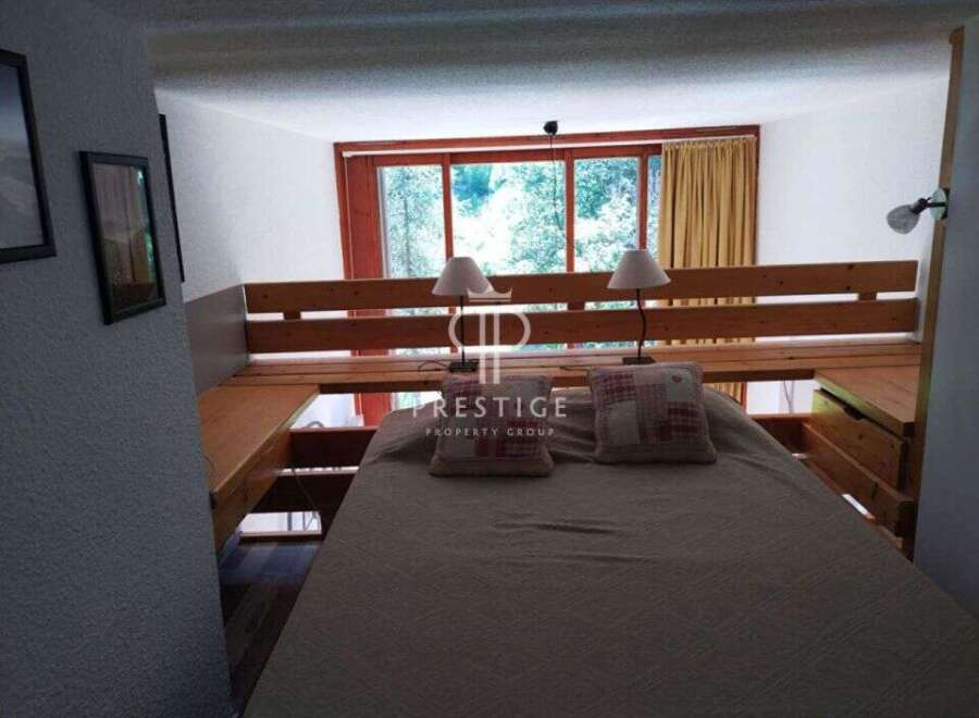 Discover a cozy bedroom with a unique loft bed design.