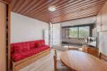 Cozy living space with a comfortable red sofa, perfect for relaxing after a day on the slopes.
