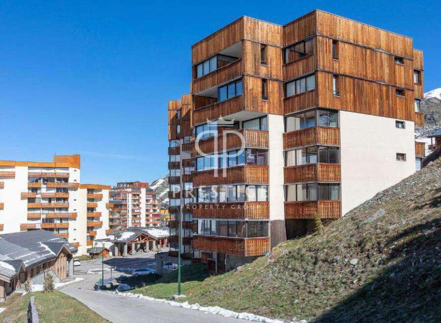 Discover a stunning property with a unique wooden facade, offering a blend of modern design and natural elements.