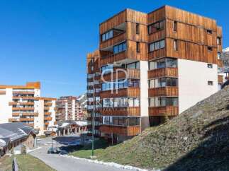 Discover a stunning property with a unique wooden facade, offering a blend of modern design and natural elements.