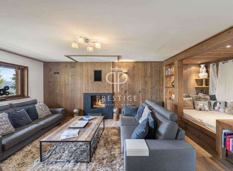 Experience luxury living in this stunning property, featuring a cozy fireplace and elegant wooden accents throughout.