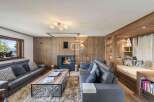 Experience luxury living in this stunning property, featuring a cozy fireplace and elegant wooden accents throughout.