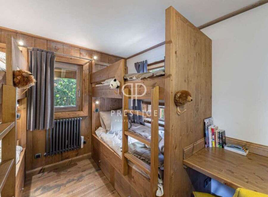 Discover the charm of this cozy bedroom featuring custom-built bunk beds, perfect for a family getaway.
